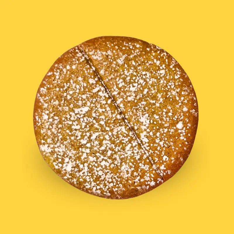 Power cookie pineapple with powdered sugar on a summer-themed background with pineapples, flowers, and suns.