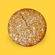 Power cookie pineapple with powdered sugar on a summer-themed background with pineapples, flowers, and suns.